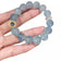 files/Ahandholdingalightbluebeadedbraceletwithagold-detailedaccentbeadandasilverdecorativeelementagainstawhitebackground.webp